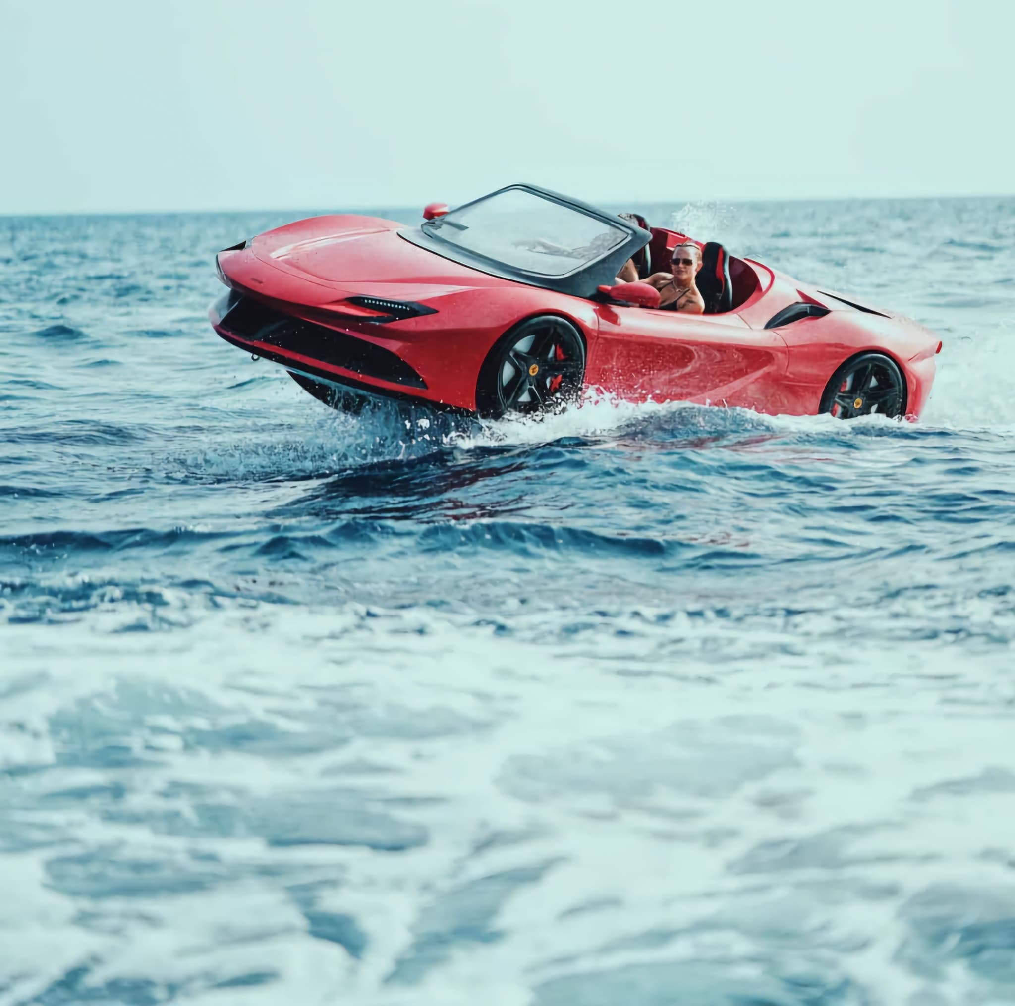 Jet car for personal use: red Ferrari-inspired WaterBoatCar jetcar cutting through open ocean waves