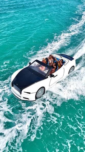 Is it legal to own a jet car: aerial view of white Rolls-Royce-inspired WaterBoatCar jetcar with passengers on open ocean