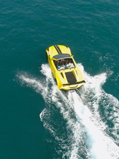 How fast do jet cars go: aerial view of WaterBoatCar yellow Lamborghini-inspired jetcar at full speed on open ocean